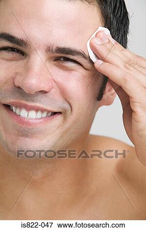Man cleaning his face View Large Photo Image Stock Photo - Man cleaning his face. Fotosearch