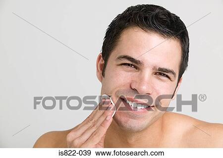 Man cleansing his skin View Large Photo Image Stock Photo - Man cleansing his skin. Fotosearch