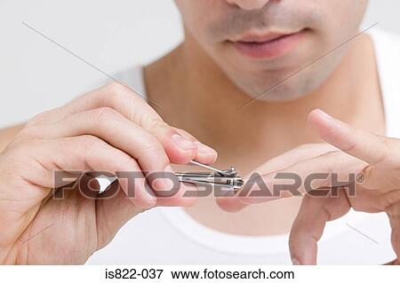 Man clipping his finger nails View Large Photo Image Stock Photo - Man clipping his finger nails. Fotosearch