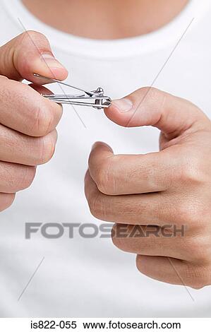 Stock Photography - Man clipping his finger nails. Fotosearch