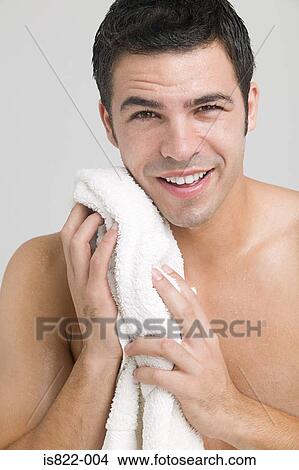 Picture - Man drying his face. Fotosearch