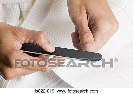 Stock Photo - Man filing his nails. Fotosearch