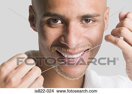 Man flossing his teeth View Large Photo Image Picture - Man flossing his teeth. Fotosearch