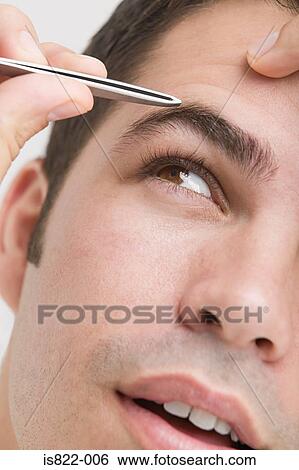 Man plucking his eyebrows View Large Photo Image Stock Photograph - Man plucking his eyebrows. Fotosearch