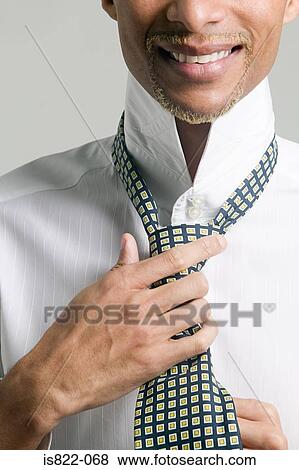 Man tying his tie View Large Photo Image Stock Photo - Man tying his tie. Fotosearch