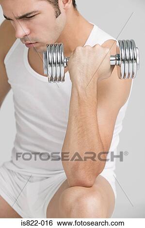 Man using a dumbbell View Large Photo Image Stock Photograph - Man using a dumbbell. Fotosearch