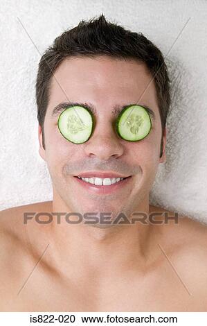 Man with cucumber slices on his eyes View Large Photo Image Stock Image - Man with cucumber slices on his eyes. Fotosearch