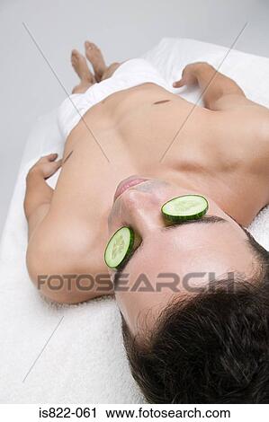 Man with cucumber slices on his eyes View Large Photo Image Stock Image - Man with cucumber slices on his eyes. Fotosearch