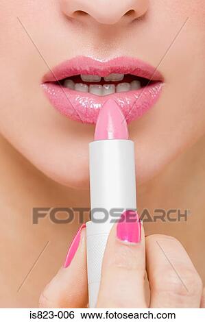 Woman applying pink lipstick View Large Photo Image Stock Photograph - Woman applying pink lipstick. Fotosearch