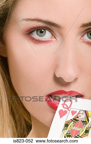 Woman biting a playing card View Large Photo Image Stock Image - Woman biting a playing card. Fotosearch