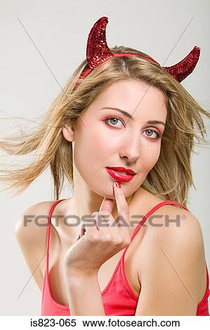 Woman wearing a devil costume View Large Photo Image Stock Photography - Woman wearing a devil costume. Fotosearch