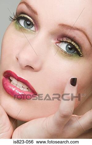 Stock Photograph - Woman wearing make up. Fotosearch