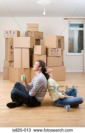 Couple taking a break from unpacking View Large Photo Image Stock Image - Couple taking a break from unpacking. Fotosearch