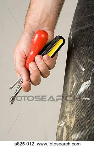 Man holding screwdrivers View Large Photo Image Stock Image - Man holding screwdrivers. Fotosearch