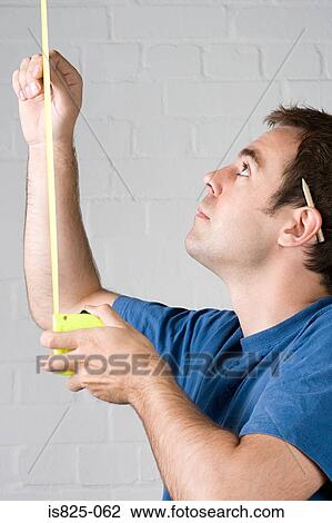 Stock Image - Man with a tape measure. Fotosearch