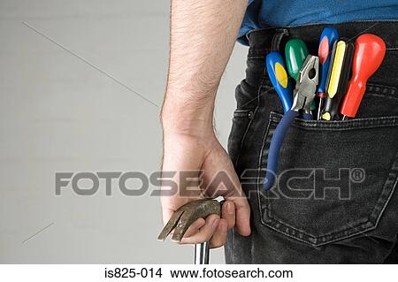 Picture - Man with tools in his pocket. Fotosearch