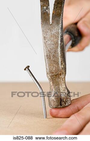 Stock Photo - Person hitting thumb with hammer. Fotosearch