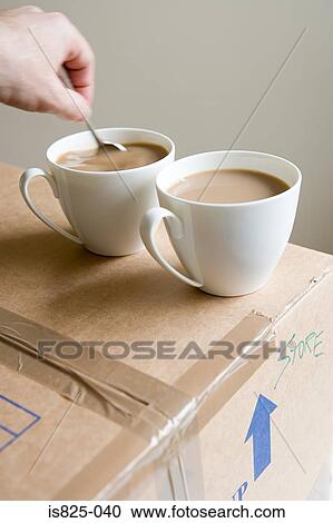 Stock Image - Person stirring tea. Fotosearch