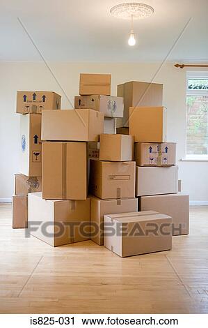 Stack of cardboard boxes in a room View Large Photo Image Stock Image - Stack of cardboard boxes in a room. Fotosearch