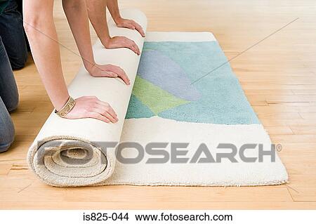 Two people rolling out rug View Large Photo Image Picture - Two people rolling out rug. Fotosearch