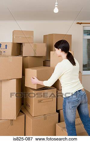Woman stacking cardboard boxes View Large Photo Image Stock Photo - Woman stacking cardboard boxes. Fotosearch