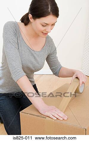 Woman taping up box View Large Photo Image Stock Image - Woman taping up box. Fotosearch