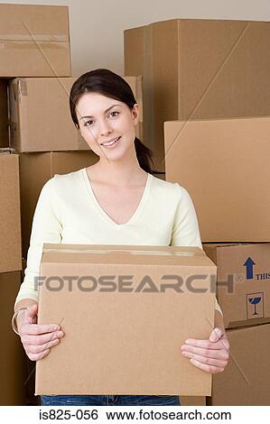 Stock Photograph - Woman with cardboard boxes. Fotosearch