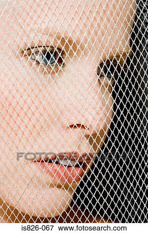 Stock Photo - Woman behind mesh. Fotosearch