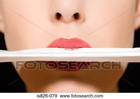 Woman blotting her lipstick View Large Photo Image Stock Photo - Woman blotting her lipstick. Fotosearch