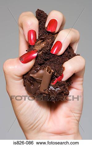 Woman crushing cake in her hand View Large Photo Image Stock Photograph - Woman crushing cake in her hand. Fotosearch
