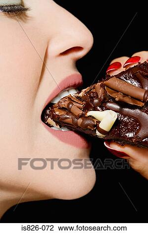 Stock Image - Woman eating chocolate cake. Fotosearch