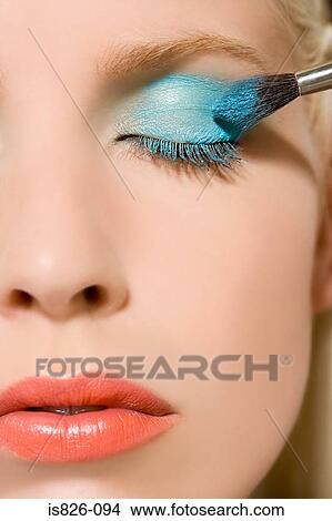 Woman having eyeshadow applied View Large Photo Image Picture - Woman having eyeshadow applied. Fotosearch