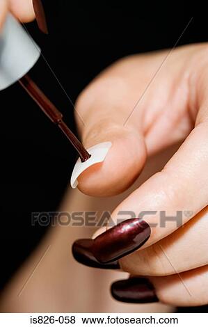 Woman painting her fingernails View Large Photo Image Stock Photo - Woman painting her fingernails. Fotosearch