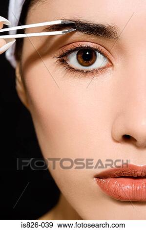 Woman plucking her eyebrows View Large Photo Image Stock Photo - Woman plucking her eyebrows. Fotosearch