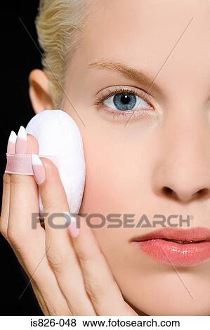 Stock Photo - Woman using powder puff. Fotosearch
