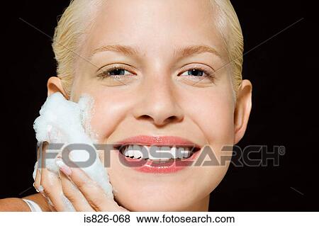 Woman washing her face View Large Photo Image Stock Photo - Woman washing her face. Fotosearch