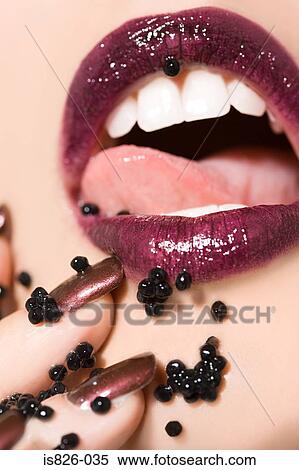 Stock Photography - Woman with caviar around her mouth. Fotosearch