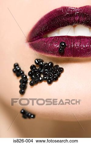 Woman with caviar on her mouth View Large Photo Image Picture - Woman with caviar on her mouth. Fotosearch