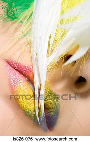 Woman with feathers and coloured lipstick View Large Photo Image Stock Photograph - Woman with feathers and coloured lipstick. Fotosearch