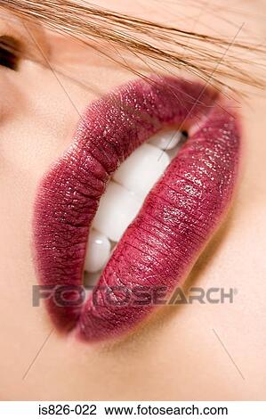 Woman with hair by her mouth View Large Photo Image Stock Image - Woman with hair by her mouth. Fotosearch