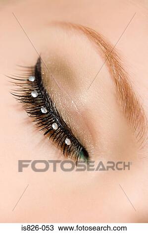 Stock Image - Woman with jewels on her eyelashes. Fotosearch