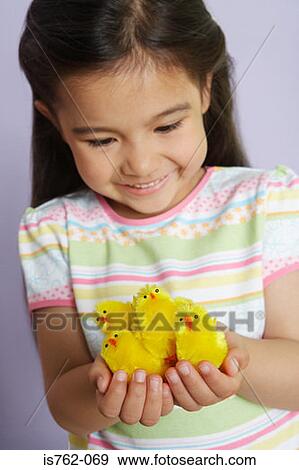 Stock Photo - Asian girl holding chicks. Fotosearch