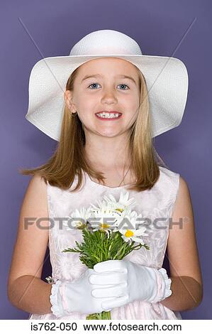 Stock Image - Girl holding a bunch of flowers. Fotosearch
