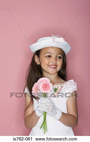 Stock Image - Girl holding a bunch of flowers. Fotosearch