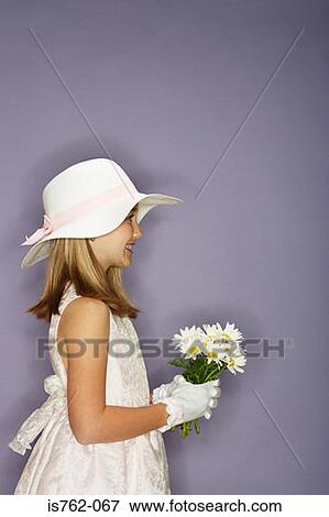Girl holding a bunch of flowers View Large Photo Image Stock Photo - Girl holding a bunch of flowers. Fotosearch