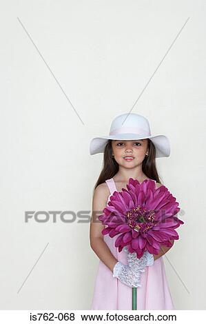 Girl holding a large flower View Large Photo Image Stock Photo - Girl holding a large flower. Fotosearch