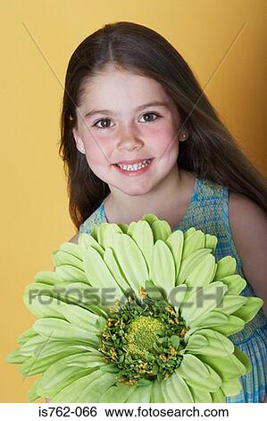 Girl holding a large green flower View Large Photo Image Stock Photograph - Girl holding a large green flower. Fotosearch