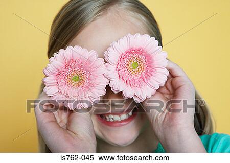 Girl holding flowers to eyes View Large Photo Image Stock Photography - Girl holding flowers to eyes. Fotosearch
