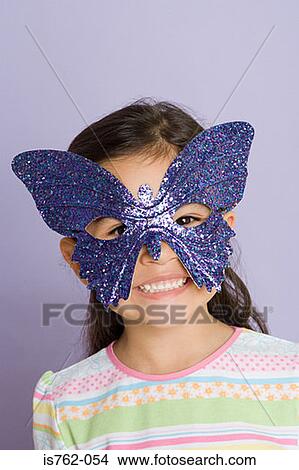 Girl wearing a butterfly eye mask View Large Photo Image Picture - Girl wearing a butterfly eye mask. Fotosearch