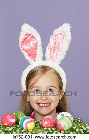 Stock Image - Girl wearing rabbit ears. Fotosearch